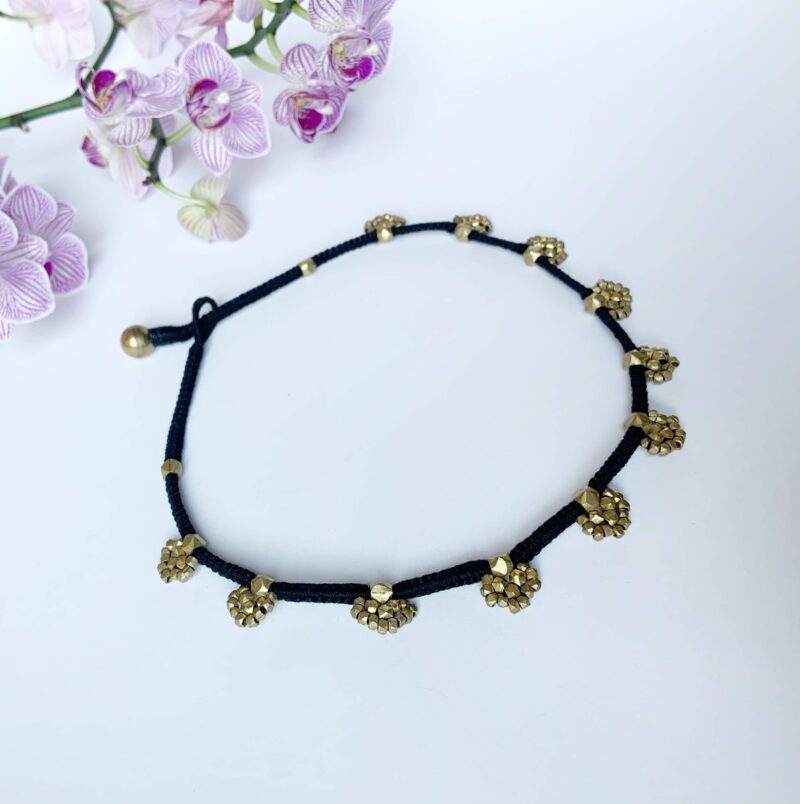 Threads of Tradition: Black and Gold Bracelet